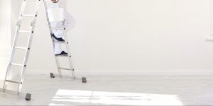 A,Male,Painter,In,A,White,Uniform,With,A,Roller